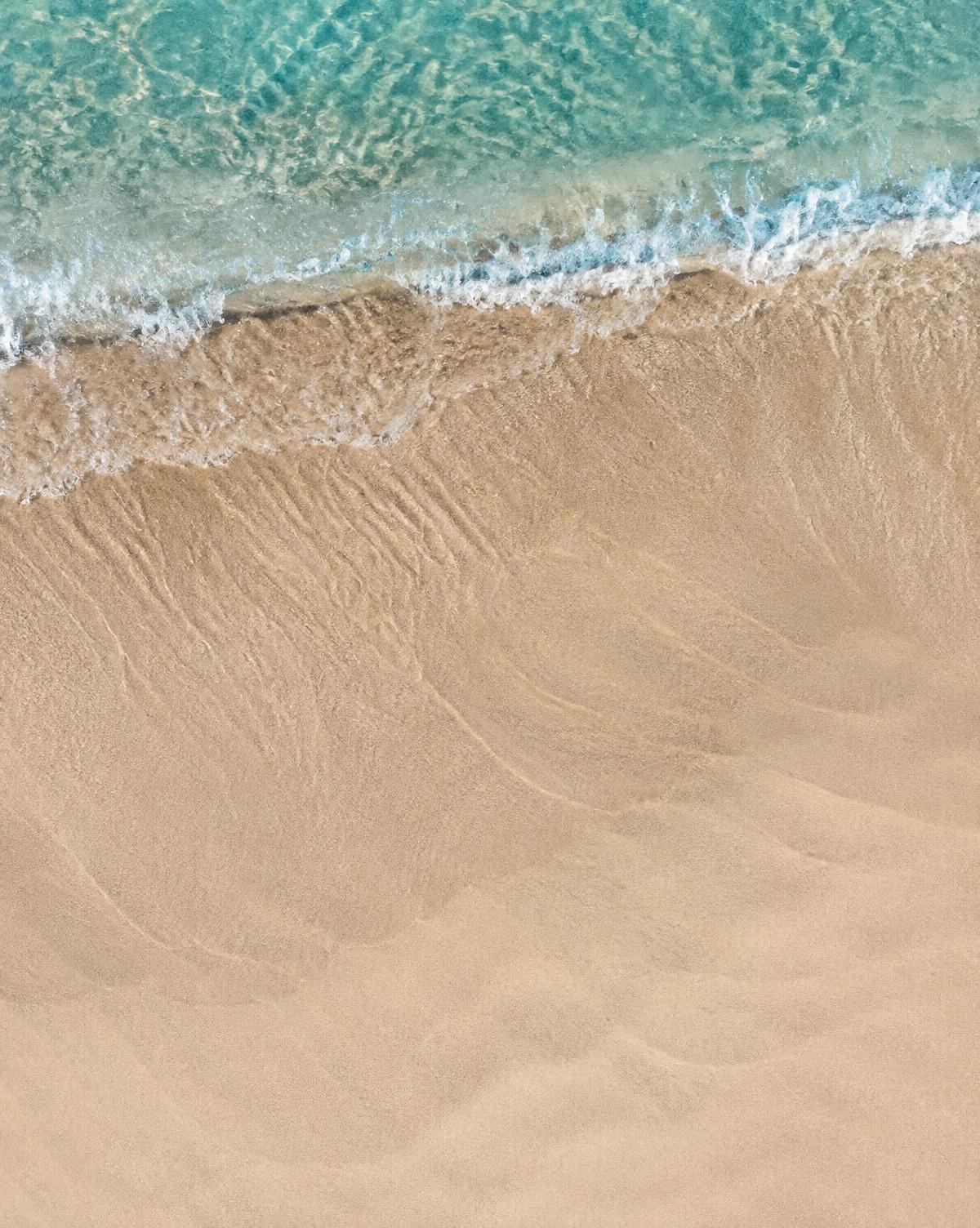 Turquoise wave washing over rippled Coffs Coast sand